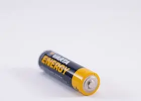 Detailed close-up of a single Varta Energy AA battery on a white background.