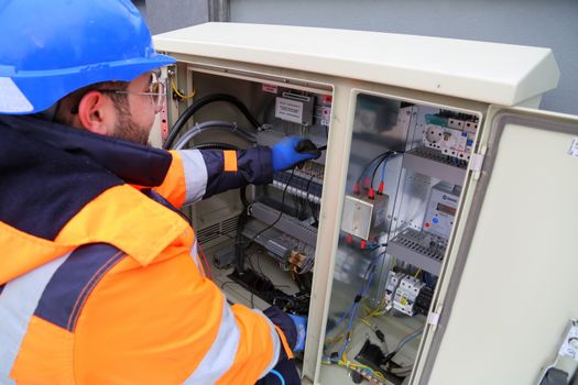 pexels photo 17842832 17842832 1 Engineer in safety gear working on an outdoor electrical panel, ensuring system functionality.